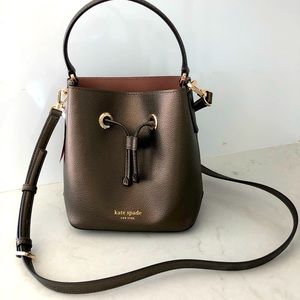 Kate Spade purse- NWT. Never used perfect condtn.Small bucket Eva- ash metallic.